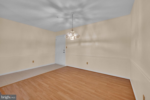4078 Rose Bud Ct, Edinburg, VA 22824 - empty room featuring a chandelier, baseboards, and wood finished floors