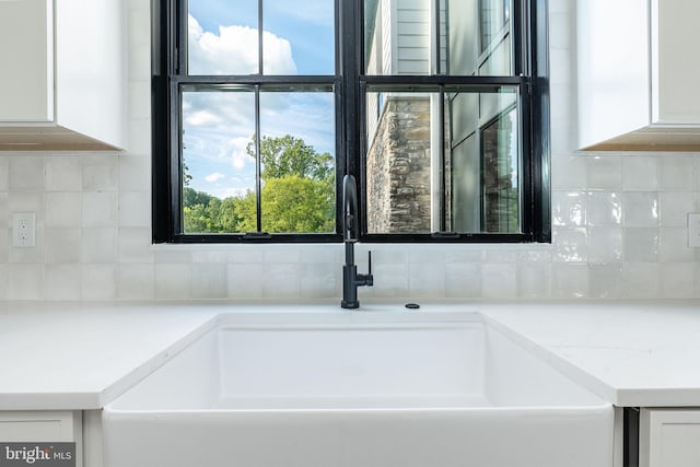 918 Ethan Allen Rd, Berwyn, PA 19312 - kitchen view of a sink, white cabinets, and backsplash