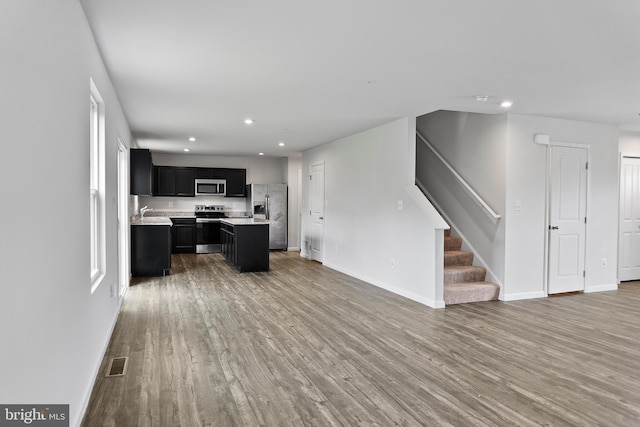 115 Shiningfield Ct, Middle River, MD 21220 - unfurnished living room with wood finished floors, stairway, baseboards, and recessed lighting