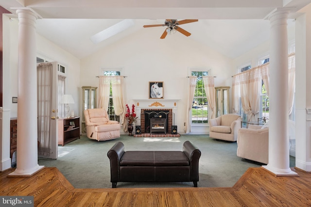 43971 Urbancrest Ct, Ashburn, VA 20147 - carpeted living room with decorative columns, high vaulted ceiling, ceiling fan, and a fireplace