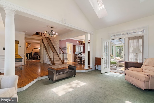 43971 Urbancrest Ct, Ashburn, VA 20147 - carpeted living area featuring crown molding, ornate columns, high vaulted ceiling, a chandelier, and stairs