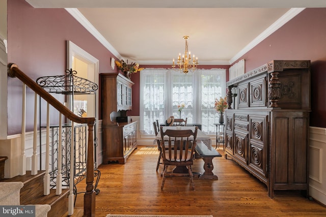 43971 Urbancrest Ct, Ashburn, VA 20147 - dining room with a chandelier, light wood-style flooring, stairs, and crown molding