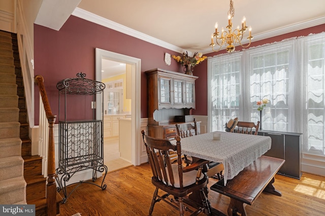 43971 Urbancrest Ct, Ashburn, VA 20147 - dining room featuring stairway, a chandelier, crown molding, and light wood-type flooring