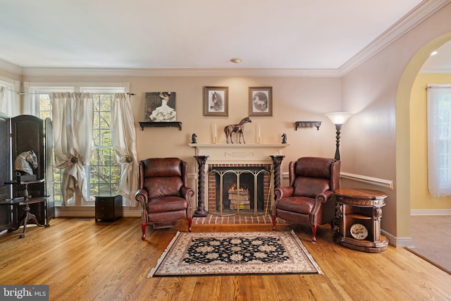 43971 Urbancrest Ct, Ashburn, VA 20147 - sitting room with arched walkways, a fireplace, wood finished floors, ornamental molding, and baseboards