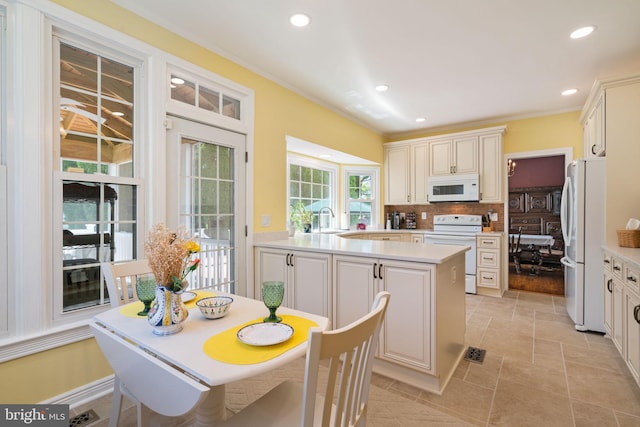 43971 Urbancrest Ct, Ashburn, VA 20147 - kitchen with white appliances, a sink, backsplash, light countertops, and recessed lighting