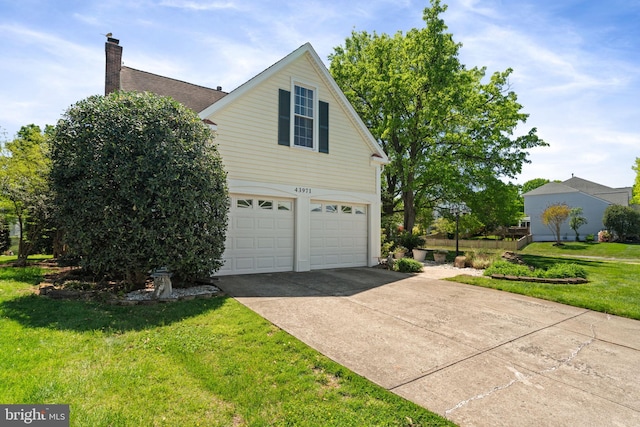 43971 Urbancrest Ct, Ashburn, VA 20147 - view of side of property featuring an attached garage, a yard, driveway, and a chimney