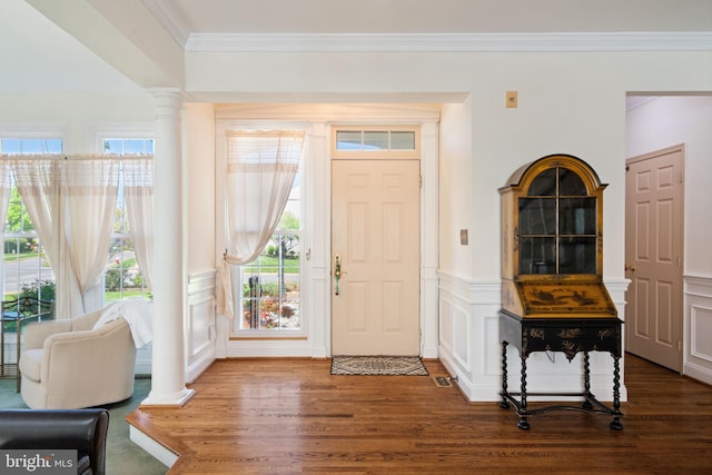 43971 Urbancrest Ct, Ashburn, VA 20147 - foyer entrance with wood finished floors, crown molding, ornate columns, a decorative wall, and a wainscoted wall