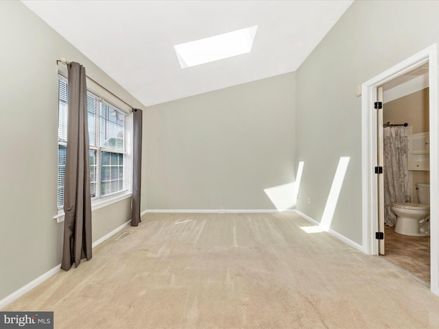231 Coventry Sq Unit 231, Sterling, VA 20164 - carpeted empty room featuring a skylight, vaulted ceiling, and baseboards