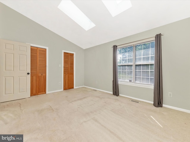 231 Coventry Sq Unit 231, Sterling, VA 20164 - unfurnished bedroom featuring a skylight, lofted ceiling, light colored carpet, multiple closets, and baseboards