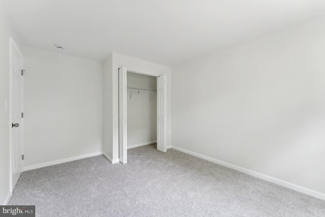13929 Carthage Cir, Burtonsville, MD 20866 - unfurnished bedroom featuring light carpet, baseboards, and a closet