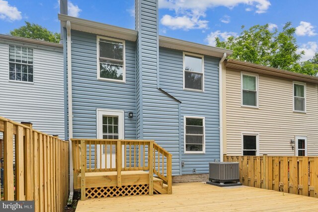 13929 Carthage Cir, Burtonsville, MD 20866 - rear view of house with cooling unit, a deck, and a chimney