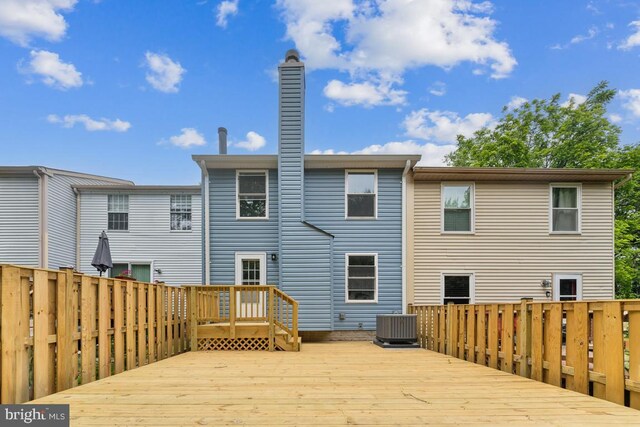 13929 Carthage Cir, Burtonsville, MD 20866 - rear view of house featuring a deck, a chimney, and cooling unit