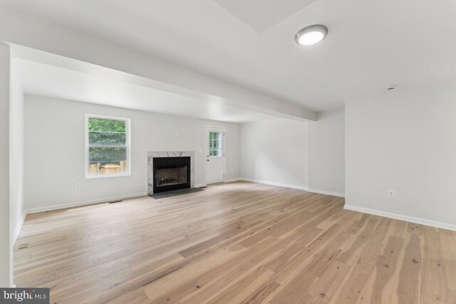 13929 Carthage Cir, Burtonsville, MD 20866 - unfurnished living room featuring light wood-style floors, a fireplace, and baseboards