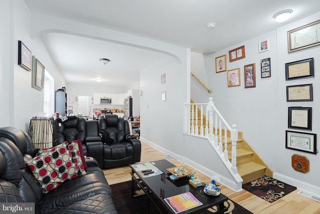 851 Carl Miller Blvd, Camden, NJ 08104 - living room featuring light wood finished floors, stairway, and baseboards
