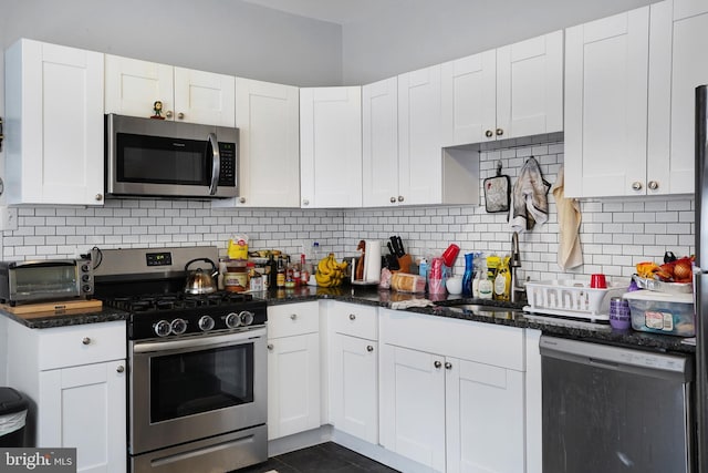 851 Carl Miller Blvd, Camden, NJ 08104 - kitchen featuring stainless steel appliances, white cabinetry, decorative backsplash, and dark stone counters