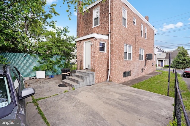 851 Carl Miller Blvd, Camden, NJ 08104 - back of property with a patio area, stone siding, and cooling unit
