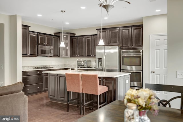 43469 Town Gate Sq, Chantilly, VA 20152 - kitchen with appliances with stainless steel finishes, dark brown cabinets, a sink, wood finished floors, and recessed lighting