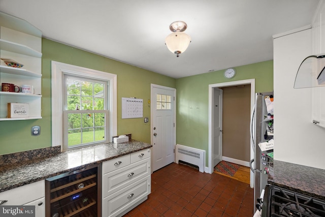 201 S Rd, Wilmington, DE 19809 - kitchen featuring wine cooler, radiator heating unit, plenty of natural light, and white cabinets