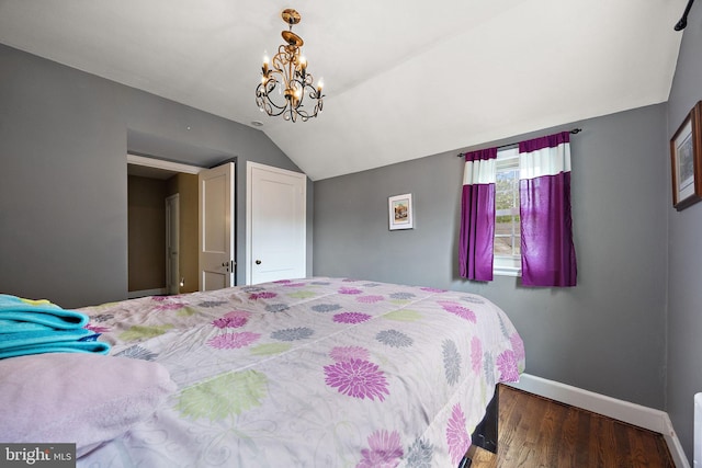 201 S Rd, Wilmington, DE 19809 - bedroom with baseboards, wood finished floors, lofted ceiling, and a chandelier