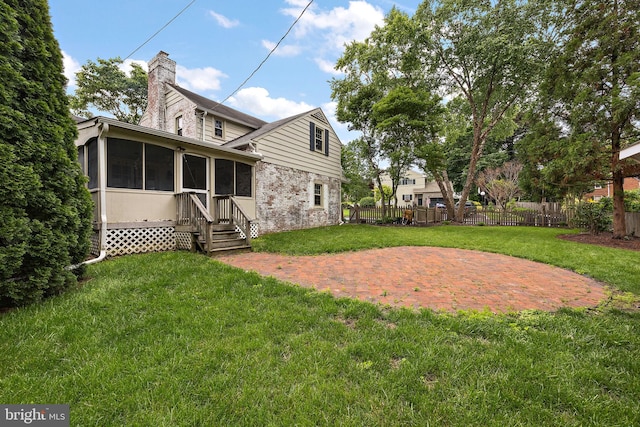 201 S Rd, Wilmington, DE 19809 - rear view of property featuring a sunroom, a patio area, a chimney, entry steps, and brick siding