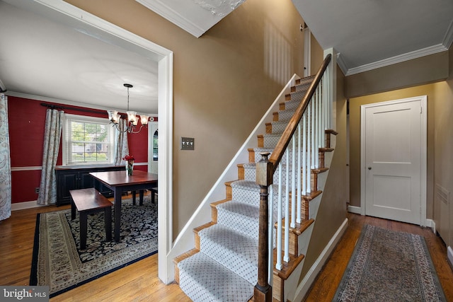201 S Rd, Wilmington, DE 19809 - stairs featuring wood finished floors, ornamental molding, a chandelier, and baseboards
