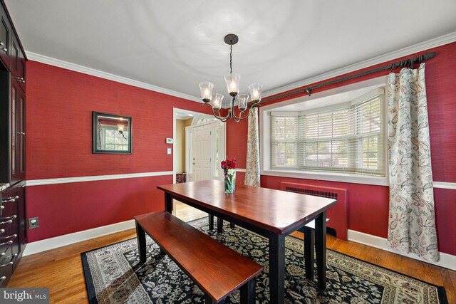 201 S Rd, Wilmington, DE 19809 - dining area with radiator, a chandelier, baseboards, ornamental molding, and wood finished floors