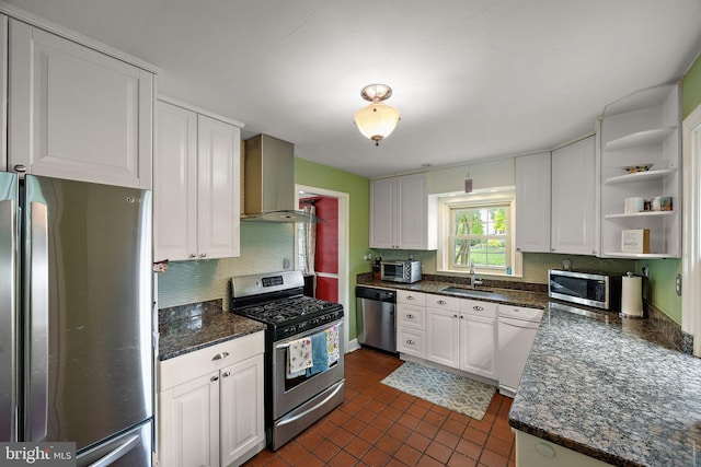 201 S Rd, Wilmington, DE 19809 - kitchen featuring appliances with stainless steel finishes, range hood, a sink, tasteful backsplash, and white cabinetry