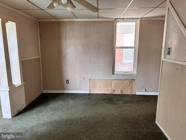 5247 Lincoln Hwy W, Thomasville, PA 17364 - empty room with a ceiling fan, carpet floors, a drop ceiling, and wood walls