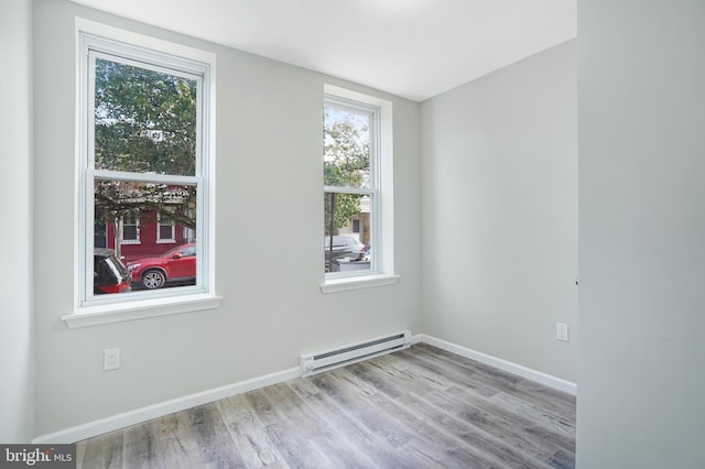 565 Line St, Camden, NJ 08103 - spare room with a baseboard radiator, wood finished floors, and baseboards