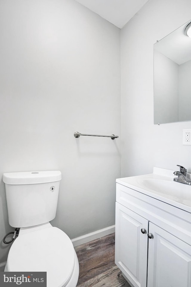 565 Line St, Camden, NJ 08103 - half bath with vanity, toilet, wood finished floors, and baseboards