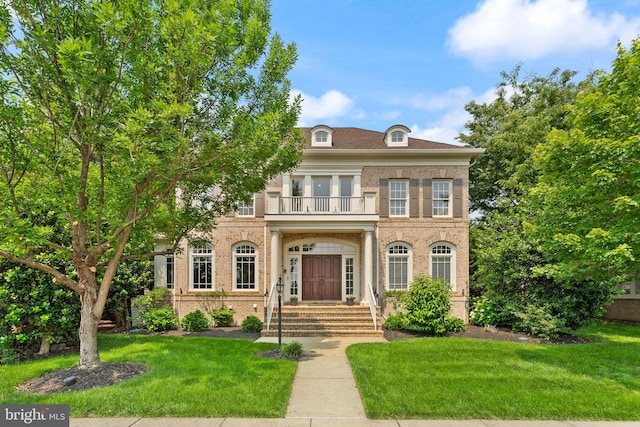 22962 Lois Ln, Brambleton, VA 20148 - colonial-style house with a balcony, brick siding, and a front lawn