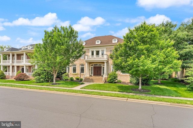 22962 Lois Ln, Brambleton, VA 20148 - view of front of home featuring a balcony and a front lawn
