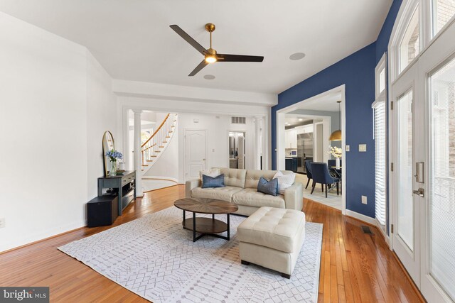 22962 Lois Ln, Brambleton, VA 20148 - living room with hardwood / wood-style flooring, stairs, ceiling fan, and baseboards