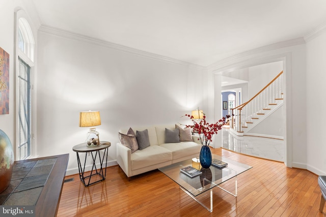 22962 Lois Ln, Brambleton, VA 20148 - living room with ornamental molding, wood-type flooring, stairway, and baseboards