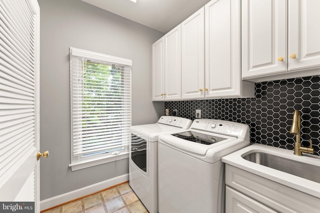 22962 Lois Ln, Brambleton, VA 20148 - laundry area with separate washer and dryer, cabinet space, and baseboards