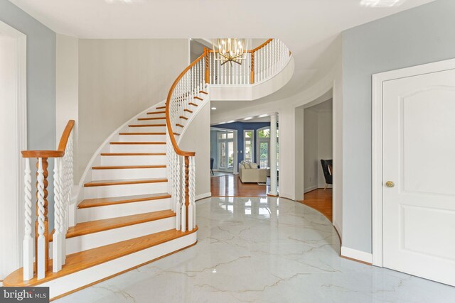 22962 Lois Ln, Brambleton, VA 20148 - stairs with marble tiled flooring, baseboards, and a chandelier