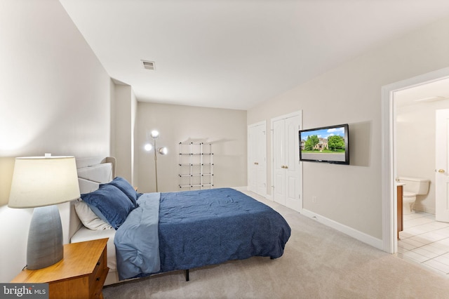 22962 Lois Ln, Brambleton, VA 20148 - tiled bedroom featuring baseboards, carpet, connected bathroom, and two closets
