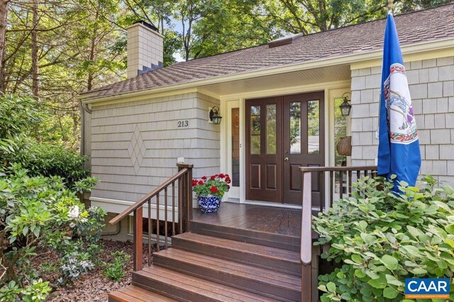 213 Turkey Ridge Rd, Charlottesville, VA 22903 - view of exterior entry featuring a chimney and roof with shingles