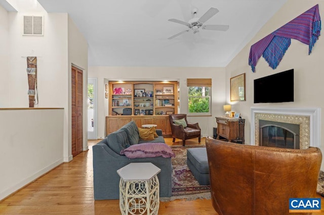 213 Turkey Ridge Rd, Charlottesville, VA 22903 - living room with wood finished floors, a glass covered fireplace, ceiling fan, baseboards, and high vaulted ceiling