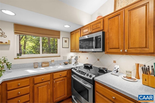 213 Turkey Ridge Rd, Charlottesville, VA 22903 - kitchen featuring appliances with stainless steel finishes, decorative backsplash, brown cabinets, and recessed lighting