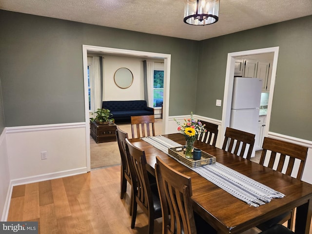 1222 Pinehurst Rd, Staunton, VA 24401 - dining area with light wood-style floors, a textured ceiling, and a chandelier