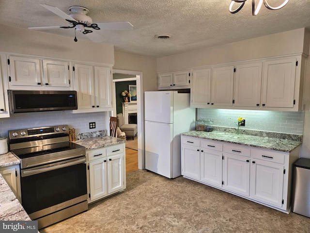 1222 Pinehurst Rd, Staunton, VA 24401 - kitchen with appliances with stainless steel finishes, decorative backsplash, white cabinetry, and a textured ceiling