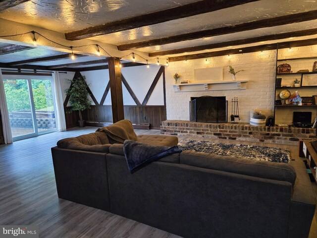 1222 Pinehurst Rd, Staunton, VA 24401 - living area with wood finished floors, beam ceiling, a brick fireplace, and wooden walls
