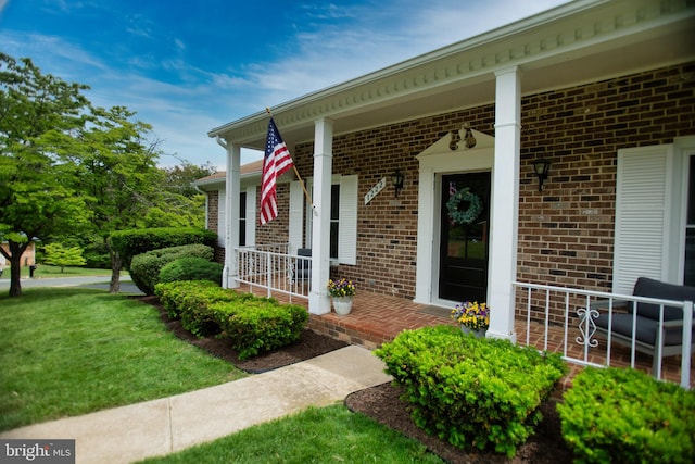 1222 Pinehurst Rd, Staunton, VA 24401 - property entrance featuring covered porch, brick siding, and a lawn