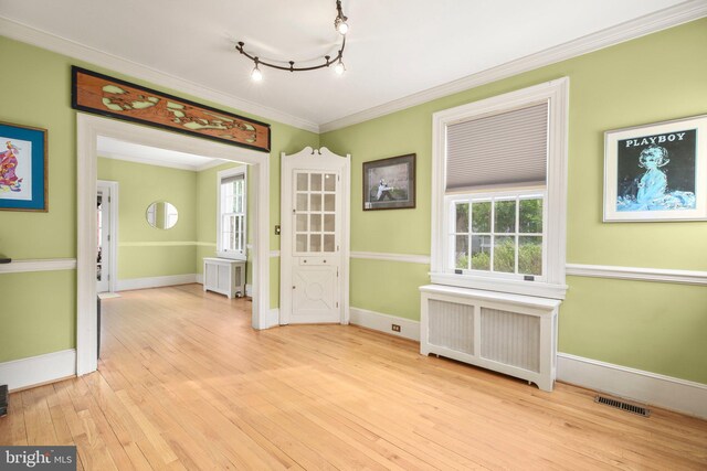 1107 Kenmore Ave, Fredericksburg, VA 22401 - spare room featuring radiator, crown molding, hardwood / wood-style floors, and baseboards