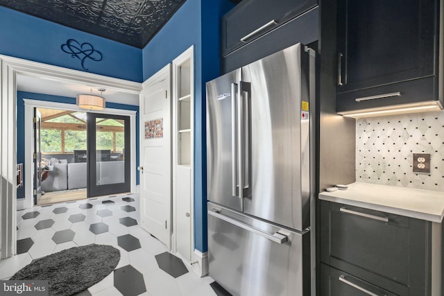 1107 Kenmore Ave, Fredericksburg, VA 22401 - kitchen with freestanding refrigerator, backsplash, light countertops, dark cabinetry, and an ornate ceiling