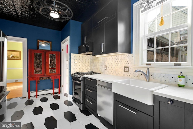 1107 Kenmore Ave, Fredericksburg, VA 22401 - kitchen with appliances with stainless steel finishes, a baseboard radiator, a sink, and dark cabinetry
