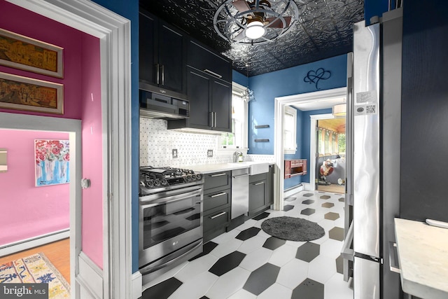 1107 Kenmore Ave, Fredericksburg, VA 22401 - kitchen featuring appliances with stainless steel finishes, light flooring, baseboard heating, light countertops, and backsplash