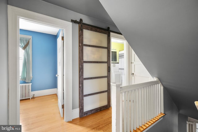 1107 Kenmore Ave, Fredericksburg, VA 22401 - corridor with radiator, light wood finished floors, baseboards, a barn door, and an upstairs landing
