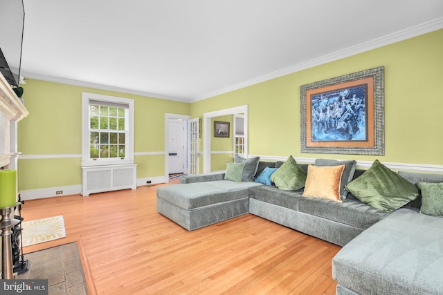 1107 Kenmore Ave, Fredericksburg, VA 22401 - living room featuring radiator heating unit, ornamental molding, wood finished floors, and baseboards